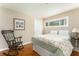 A cozy bedroom with hardwood floors, rocking chair and a sunny window at 2590 Hawthorne Ne Pl, Atlanta, GA 30345