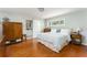 Bright main bedroom with hardwood floors, a large dresser, and ensuite bathroom at 2590 Hawthorne Ne Pl, Atlanta, GA 30345