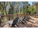 Large wooden deck with outdoor seating overlooking mature trees provides a relaxing outdoor living space at 2806 Chaucer Sw Dr, Atlanta, GA 30311