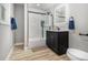 This bathroom features a vanity, a modern shower with sliding glass doors, and matte black accents at 2806 Chaucer Sw Dr, Atlanta, GA 30311