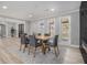 Bright dining room with natural light, wood floors, modern furnishings, and a view to the backyard at 2806 Chaucer Sw Dr, Atlanta, GA 30311