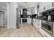 Modern kitchen with stainless steel appliances, white cabinetry, and a view of adjacent rooms at 2806 Chaucer Sw Dr, Atlanta, GA 30311