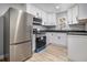 Modern kitchen featuring stainless steel appliances, white cabinetry, and updated countertops at 2806 Chaucer Sw Dr, Atlanta, GA 30311