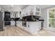 Well-appointed kitchen features white cabinetry, black countertops, wine racks, and modern appliances at 2806 Chaucer Sw Dr, Atlanta, GA 30311