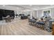 Spacious living room featuring stylish furnishings, light wood floors, and an open concept design to the kitchen at 2806 Chaucer Sw Dr, Atlanta, GA 30311