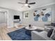 Cozy living room with plush seating, a ceiling fan, and a view to an adjacent room at 2806 Chaucer Sw Dr, Atlanta, GA 30311
