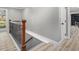The house's staircase features dark iron railings and a wooden banister with light-colored wooden floors at 2806 Chaucer Sw Dr, Atlanta, GA 30311