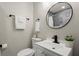 Charming bathroom featuring round mirror, vessel sink, and decorative plants at 3460 Fairlane Dr, Atlanta, GA 30331