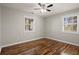 Bedroom with hardwood floors, two windows, and a ceiling fan at 3460 Fairlane Dr, Atlanta, GA 30331