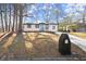 Charming home with blue door, mailbox, mature trees, and well-maintained lawn at 3460 Fairlane Dr, Atlanta, GA 30331