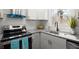 Bright kitchen featuring stainless steel appliances, gray granite countertops, and gold hardware at 3460 Fairlane Dr, Atlanta, GA 30331