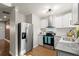 Well-lit kitchen with stainless steel appliances, shaker cabinets and stone countertops at 3460 Fairlane Dr, Atlanta, GA 30331