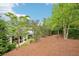 Expansive backyard with tiered landscaping and covered patio with comfortable seating at 4025 Connolly Ct, Roswell, GA 30075