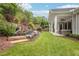 Backyard with mature landscaping, stone accents, and a covered outdoor seating area at 4025 Connolly Ct, Roswell, GA 30075