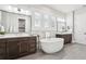 Bright bathroom featuring double vanities, a soaking tub, and tile floors for a spa-like experience at 4025 Connolly Ct, Roswell, GA 30075