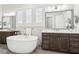 Bright bathroom with a soaking tub, double vanity, shuttered windows, and a modern design at 4025 Connolly Ct, Roswell, GA 30075