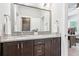 Granite countertop and dual sinks featured in this en-suite bathroom with dark wood cabinets at 4025 Connolly Ct, Roswell, GA 30075