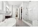 Bright bathroom featuring a glass shower, soaking tub, and a view into the bedroom at 4025 Connolly Ct, Roswell, GA 30075