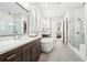 Bright bathroom showcases a soaking tub, glass shower, and double vanity, creating a luxurious retreat at 4025 Connolly Ct, Roswell, GA 30075