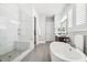 Bright bathroom featuring a glass shower, soaking tub, double vanity and tile floors at 4025 Connolly Ct, Roswell, GA 30075
