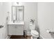 Powder room features a gray vanity with stone countertop, chrome hardware, and a decorative mirror at 4025 Connolly Ct, Roswell, GA 30075