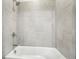 Tiled bathtub and shower combo with sleek gray tiles and modern fixtures at 4025 Connolly Ct, Roswell, GA 30075