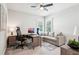 Bright bedroom featuring a ceiling fan, window shutters, and a full work desk set up at 4025 Connolly Ct, Roswell, GA 30075