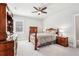 Comfortable bedroom with neutral walls, ceiling fan, and coordinated wood furniture set at 4025 Connolly Ct, Roswell, GA 30075