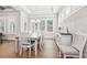 Elegant dining room with hardwood floors, bright windows, and decorative brick wall at 4025 Connolly Ct, Roswell, GA 30075