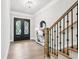 Bright foyer featuring hardwood floors, staircase, and stylish entry table at 4025 Connolly Ct, Roswell, GA 30075