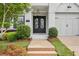 Stunning front entrance with black double doors, brick facade, and well-kept landscaping at 4025 Connolly Ct, Roswell, GA 30075