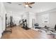 Home gym featuring hardwood floors, gym equipment, and a ceiling fan at 4025 Connolly Ct, Roswell, GA 30075