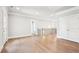 Open hallway with hardwood floors, white trim and doors, and a staircase at 4025 Connolly Ct, Roswell, GA 30075