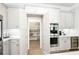 Walk-in pantry shown in a spacious kitchen with modern stainless steel appliances and designer tile backsplash at 4025 Connolly Ct, Roswell, GA 30075