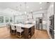Bright, open kitchen with white cabinets, stainless steel appliances, and large island with seating at 4025 Connolly Ct, Roswell, GA 30075