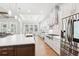 Spacious, modern kitchen with white cabinets, stainless steel appliances, a large island, and an eat-in dining area at 4025 Connolly Ct, Roswell, GA 30075