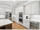 Modern kitchen with stainless steel appliances, wine cooler, white cabinets, and quartz countertops at 4025 Connolly Ct, Roswell, GA 30075