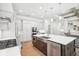 Bright kitchen features white cabinets, a large island with a stainless steel sink, and stainless steel appliances at 4025 Connolly Ct, Roswell, GA 30075