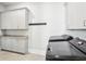 Well-organized laundry area with modern washer and dryer and plenty of storage cabinets at 4025 Connolly Ct, Roswell, GA 30075