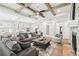 Spacious living room featuring hardwood floors, coffered ceilings, and a stone fireplace at 4025 Connolly Ct, Roswell, GA 30075