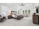 Spacious main bedroom with tray ceiling, plush carpet, and large windows with plantation shutters at 4025 Connolly Ct, Roswell, GA 30075
