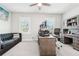 Home office features a gray couch, two windows, and a built-in desk area with storage at 4025 Connolly Ct, Roswell, GA 30075