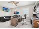 Office space includes a gray couch, two windows and a desk with built in storage and shelving at 4025 Connolly Ct, Roswell, GA 30075