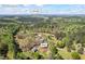 Expansive aerial view of the property with lake views and surrounding woods in Covington, GA at 700 Stewart Rd, Covington, GA 30016
