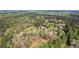 A peaceful aerial view of the property surrounded by lush greenery and beautiful, mature trees at 700 Stewart Rd, Covington, GA 30016