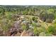 Aerial view of a country estate showing the home, outbuildings, pool, and landscaping, offering a serene escape at 700 Stewart Rd, Covington, GA 30016