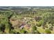 Areal view of a home nestled among lush greenery with a lake visible in the distance, located in Covington, GA at 700 Stewart Rd, Covington, GA 30016