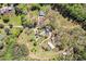 Expansive aerial view of a country estate featuring lush landscaping, pool, outbuildings, and a long private driveway at 700 Stewart Rd, Covington, GA 30016
