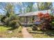 Lush backyard featuring an open-air covered porch and landscaped pathway at 700 Stewart Rd, Covington, GA 30016