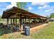 View of a wooden open barn structure with tractor and farm equipment inside at 700 Stewart Rd, Covington, GA 30016